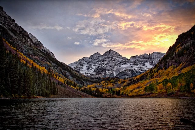 A lake and Colorado mountains at dusk