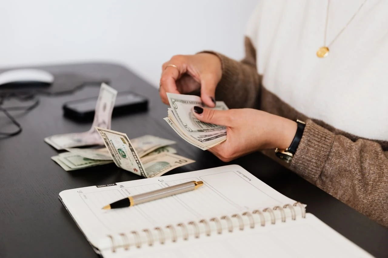 A landlord counting cash from their bank accounts,the rent they have collected
