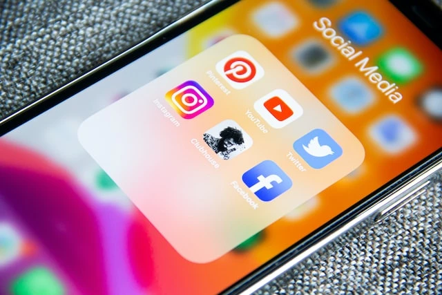 A smartphone screen open to a Social Media folder with app icons