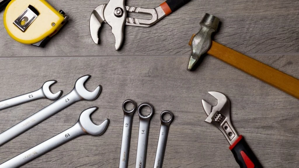 An assortment of tools on a wooden table