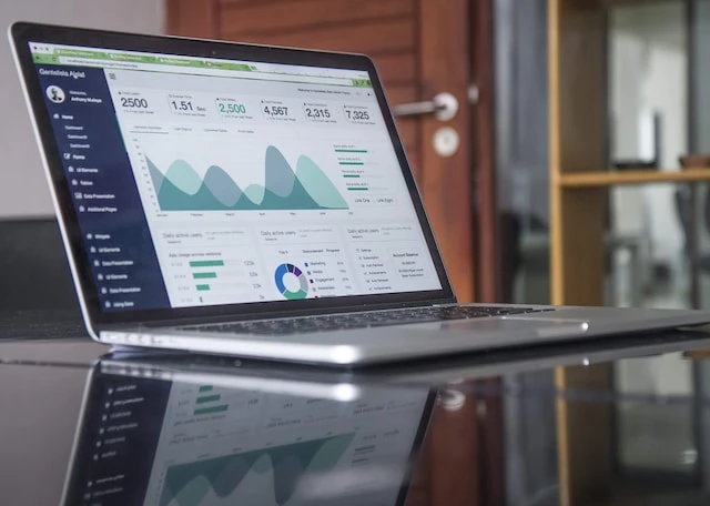 laptop open to a page of graphs