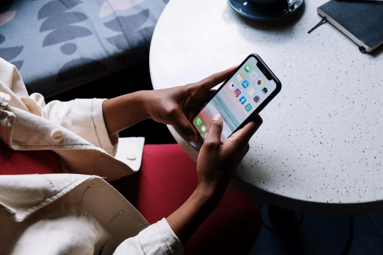 close up of a person using their phone to pay rent online