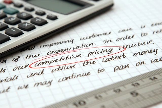Close up of a piece of paper with the words competitive pricing circled in red