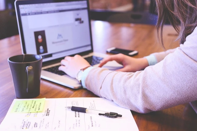 Close up of a property manager working on their laptop at their desk