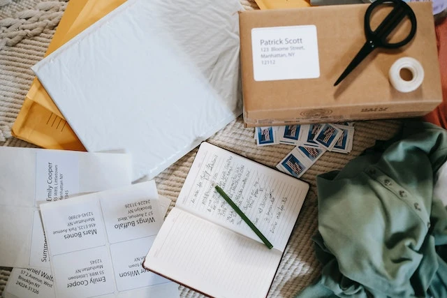 Composition of opened diary carton parcel and postage stamps