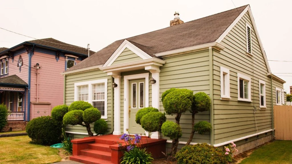 A small single-family house painted green