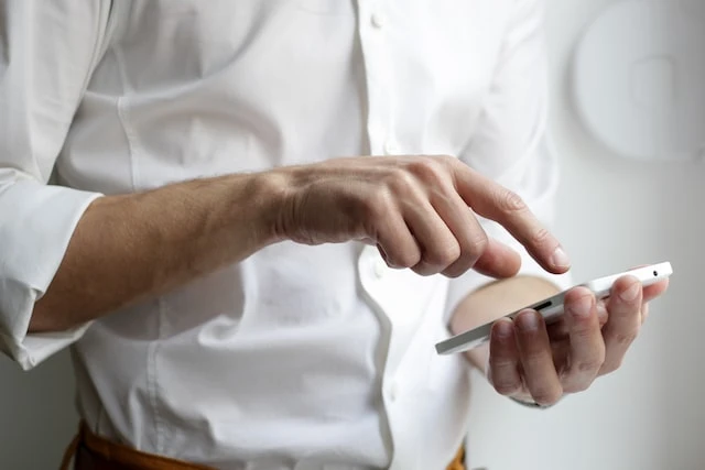 Cropped image of a person typing on their smartphone