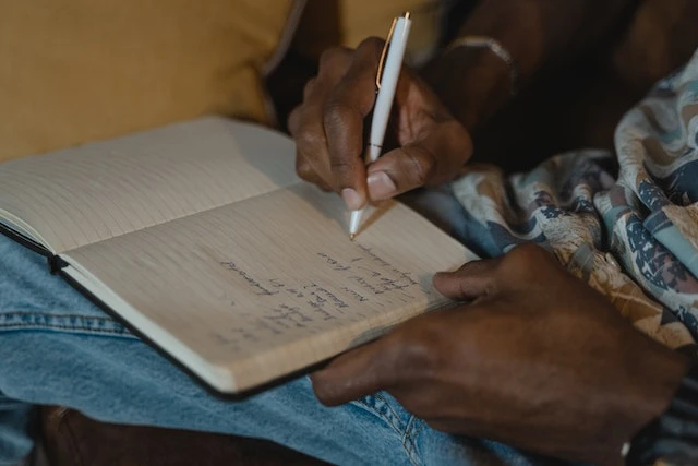 Cropped image of someone’s hands writing a to-do list
