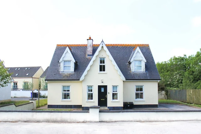Exterior of a white and grey cottage
