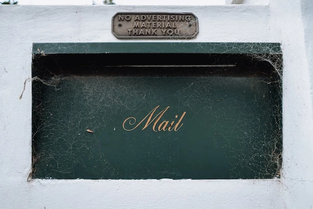Green Mailbox on a Wall