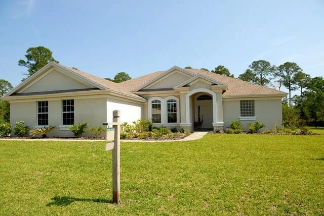 Home with a for sale sign in the front yard