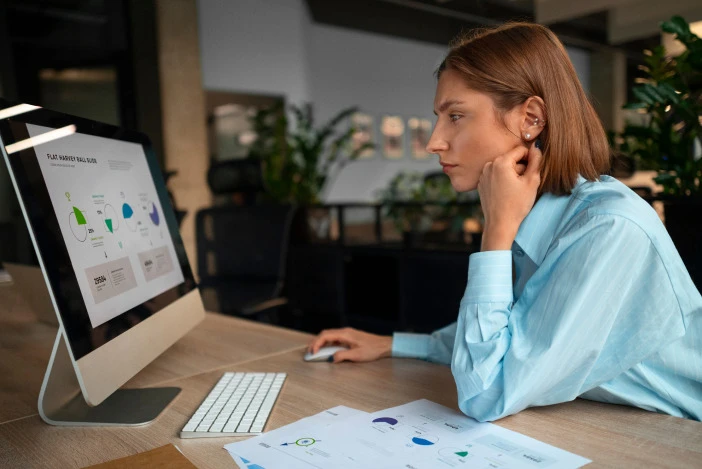 Property manager reviewing financial charts on a desktop computer