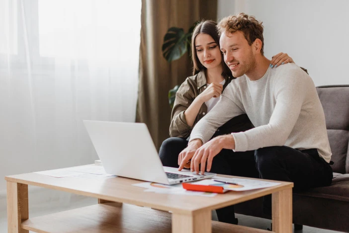 Couple reviewing their property report together on a laptop at home