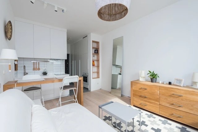 Minimalist design of contemporary apartment with white and wooden furniture