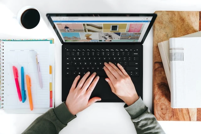 Overhead shot of someone using thier laptop to work on their marketing strategy