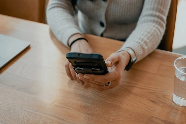 Person sitting at a table texting