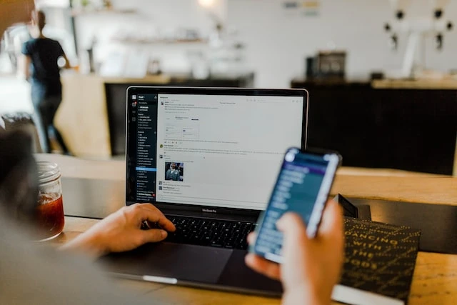 A property manager using their phone and laptop at the same time