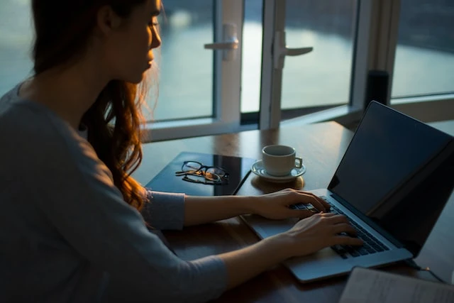 A property manager working on their laptop at dusk