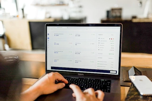 Person’s hands typing on a laptop