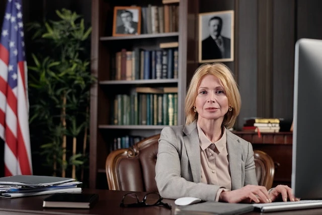 A lawyer sitting behind their desk
