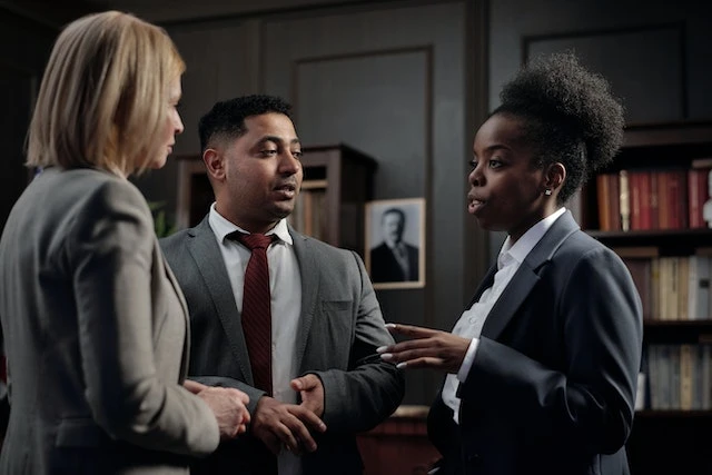 Three lawyers standing and talking to each other