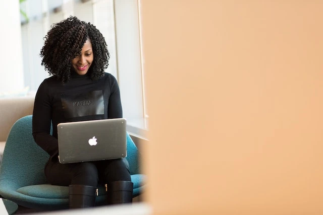 Person working on a laptop sitting in a chair