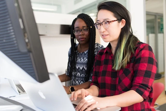 Two people working together on a computer