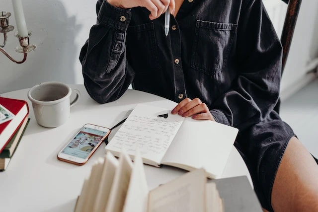 Person writing in a notebook