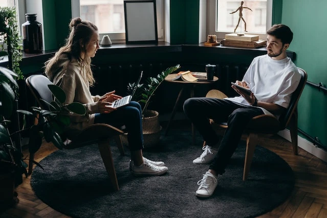 Two people sitting across from each other having a conversation