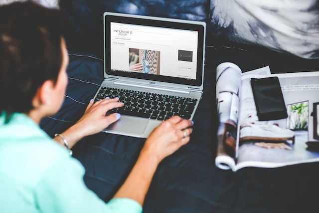 Property manager using their laptop on their bed