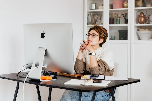 Person sitting in a home office working on a desktop