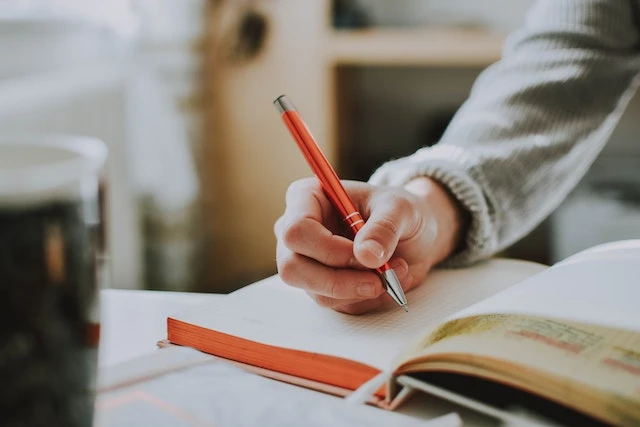 Person taking notes in a notebook