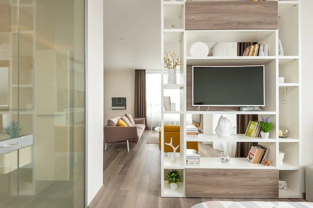 Shelf in a house with a large TV on it