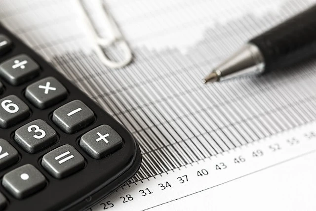 Pen and calculator on top of tax documents