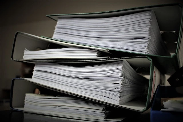 A stack of binders full of paper