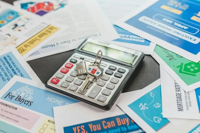 Variety of colorful documents underneath a calculator with a key on top