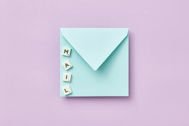 Scrabble Tiles spell out mail on an Envelope