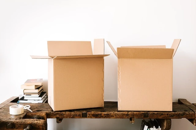 two brown cardboard boxes on top of a table