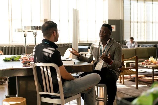 Two landlords having a conversation in a cafe