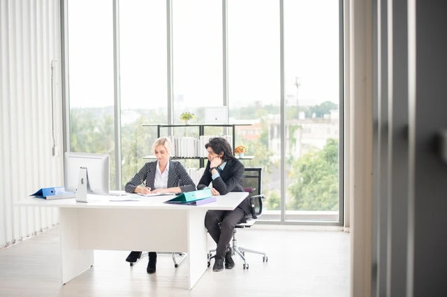 Two property managers looking at a computer in an office