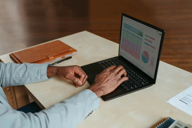 Hands working on a laptop