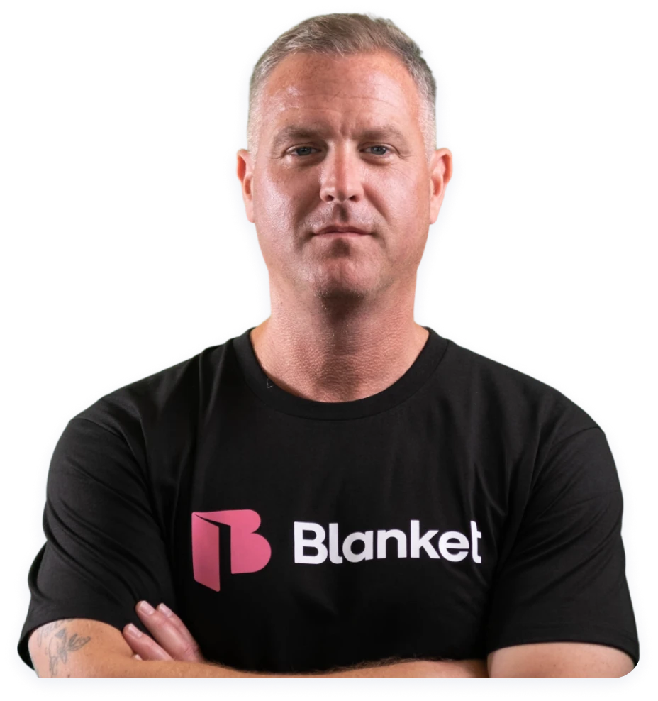 Jeff J. Grice, who leads Blanket Advisory, arms crossed in a Blanket t-shirt