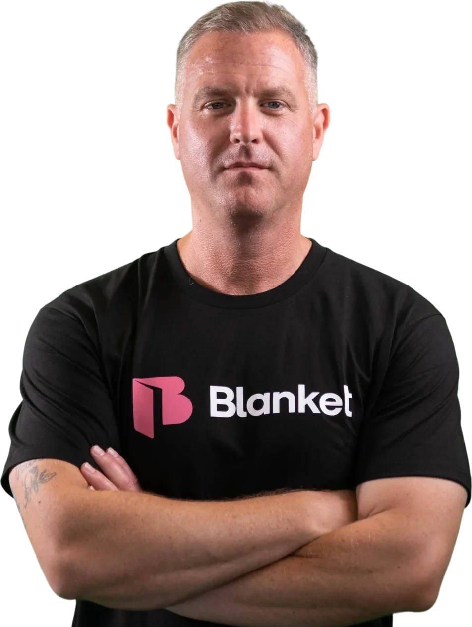 Jeff Grice, who leads Blanket Advisory, wearing a Blanket t-shirt with arms crossed