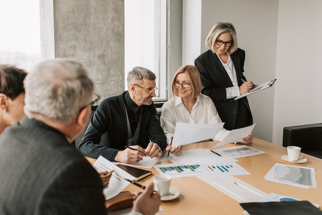 Colleagues looking at documents around a conference table