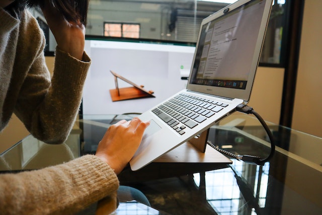 Close up of a person working on a laptop
