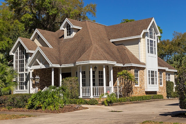 Brown and white house with trees and a blue sky