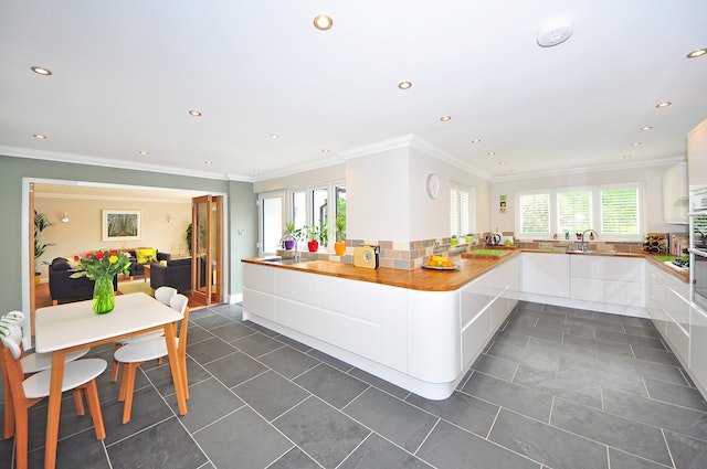 Interior of a white kitchen with grey slate floors