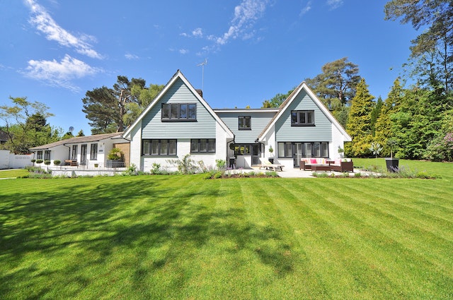 White two-story house with a large green lawn
