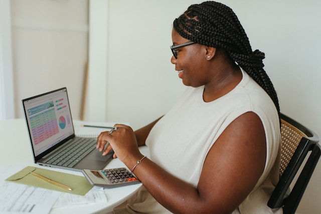 Person sitting at a desk working on their laptop