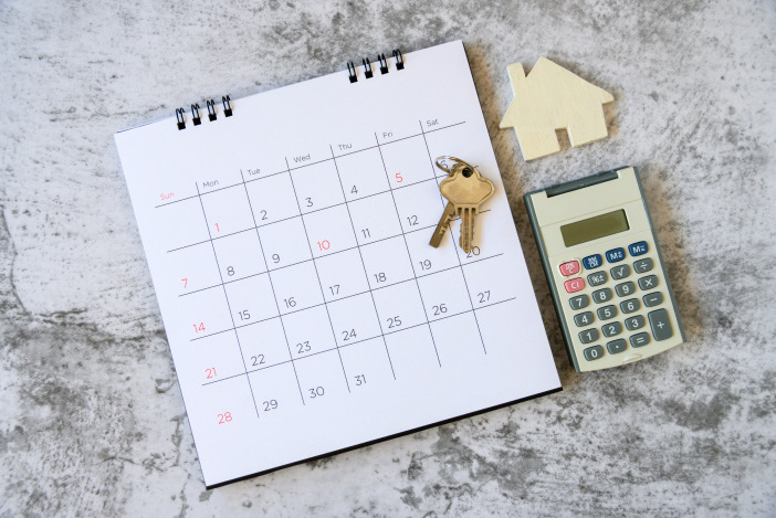 A calendar next to a calculator with keys on top